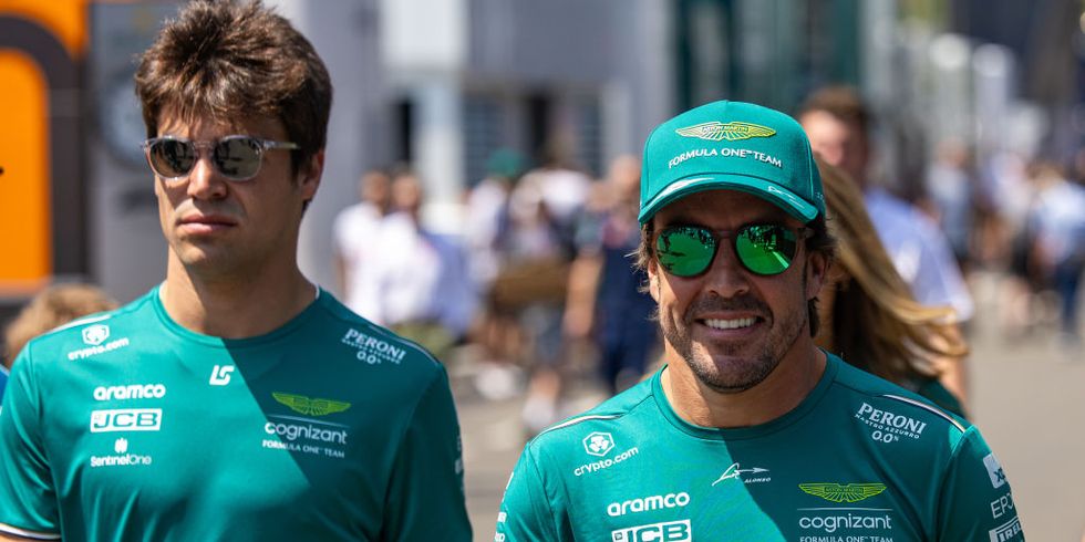 lance stroll y fernando alonso caminan por el paddock de f1 en austria